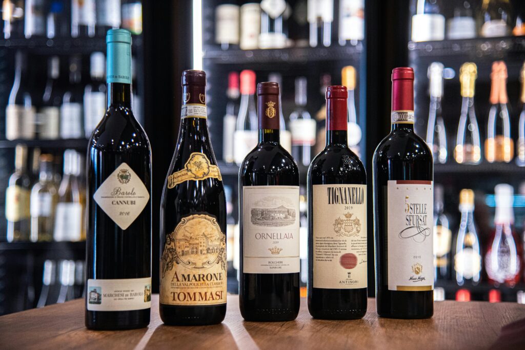 A premium collection of Italian red wines elegantly displayed in a wine store setting.